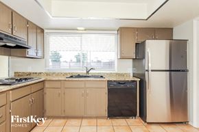 Phoenix house for rent - A kitchen with a stainless steel refrigerator and a black trash can.