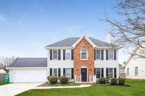 High Point house for rent - A large white house with a brick chimney and a black front door.