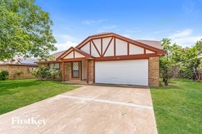 Fort Worth house for rent - a home with a driveway and a garage door