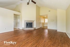 Fort Worth house for rent - a living room with a fireplace and wooden floors