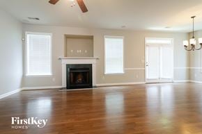 Cumming house for rent - a living room with a fireplace and a wooden floor