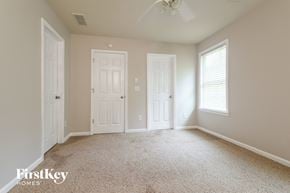 Cumming house for rent - a bedroom with two white doors and a carpeted floor