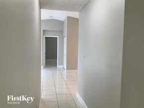 Miami Gardens house for rent - an empty hallway with a tiled floor and a door