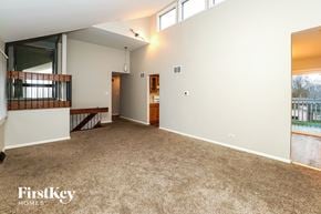 Hazel Crest house for rent - a living room with a carpeted floor and a balcony