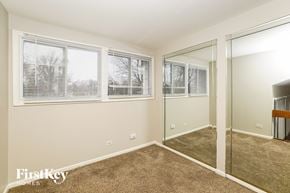 Hazel Crest house for rent - a bedroom with a large mirror and a carpeted floor