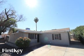 Tempe house for rent - A house with a palm tree in the backyard.