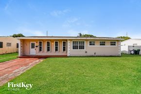 Miami Gardens house for rent - A house with a red brick pathway leading to the front door.