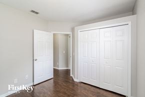 North Port house for rent - the living room of an apartment with white doors and wood floors
