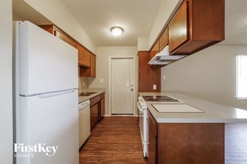 Phoenix house for rent - a kitchen with white appliances and wooden cabinets and a refrigerator