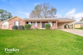 Memphis house for rent - a brick house with a lawn in front of it