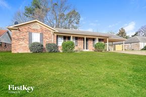 Memphis house for rent - a brick house with a lawn in front of it