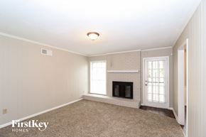Memphis house for rent - a living room with a fireplace and a carpeted floor