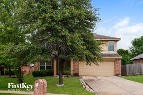Dallas house for rent - A house with a tree in front of it.