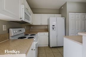Homestead house for rent - a kitchen with white appliances and a white refrigerator