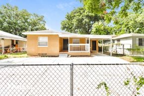 Tampa house for rent - a small house with a fence in front of it