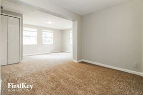 Tampa house for rent - a bedroom with a white door and a carpeted floor