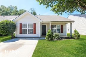 Charlotte house for rent - A white house with red shutters and a grey roof.