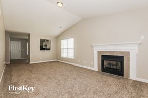 Charlotte house for rent - A spacious living room with a fireplace and a television.