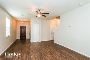 Houston house for rent - A spacious room with wooden floors and a ceiling fan.