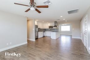 Phoenix house for rent - A spacious kitchen and living room with a wood floor and a ceiling fan.