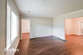 Memphis house for rent - an empty living room with wood floors and white walls
