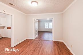 Memphis house for rent - the living room and dining room of an empty house with wood flooring