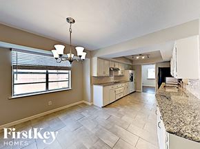 Garland house for rent - A kitchen with a granite counter top and a chandelier.