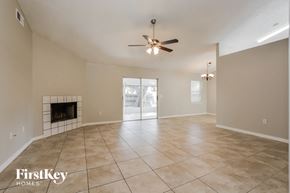 Winter Haven house for rent - the living room has a fireplace and tile flooring and a ceiling fan
