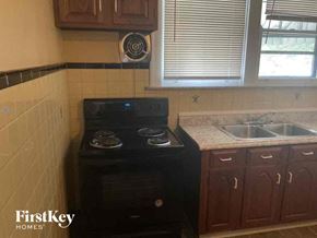 Cincinnati house for rent - a small kitchen with a stove and a sink