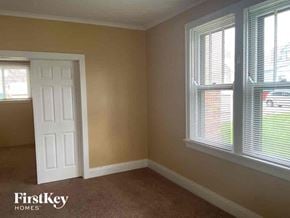 Cincinnati house for rent - an empty room with a white door and two windows