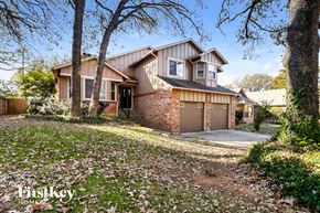 Arlington house for rent - the front of a house with a garage and trees
