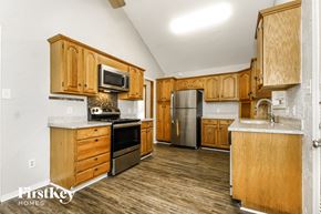 Arlington house for rent - a kitchen with wooden cabinets and stainless steel appliances