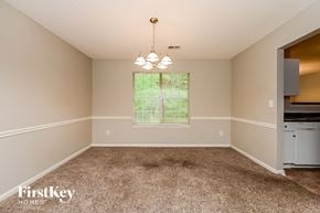 Decatur house for rent - an empty dining room with carpet and a window