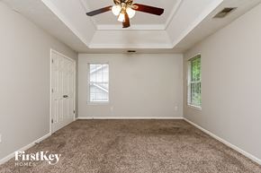 Decatur house for rent - the master bedroom has a ceiling fan and a carpeted floor