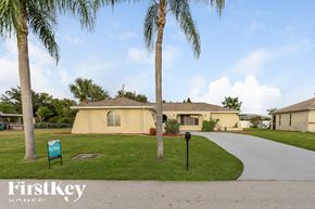 Cape Coral house for rent - A palm tree stands in front of a house with a sign that says FirstKey Homes.