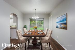 Cape Coral house for rent - A dining room with a wooden table and chairs.