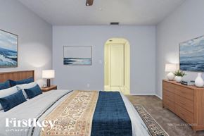 Cape Coral house for rent - A bedroom with a bed, nightstand, and two paintings on the wall.