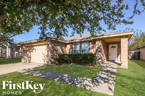 Dallas house for rent - a tan brick house with a driveway and grass