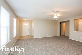 Dallas house for rent - an empty living room with a ceiling fan and window