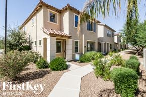 Gilbert house for rent - a house with a sidewalk and landscaping in front of it