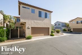 Gilbert house for rent - a beige house with a garage door on a street