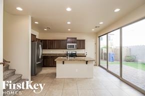Gilbert house for rent - a kitchen with stainless steel appliances and a granite counter top