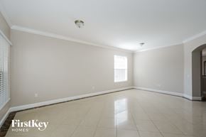 Land O'lakes house for rent - an empty living room with tiled floors and a window