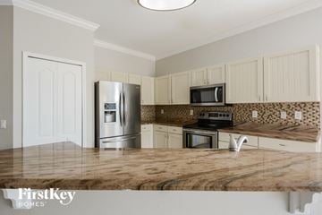 Land O'lakes house for rent - a kitchen with stainless steel appliances and a wooden counter top