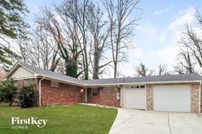 Decatur house for rent - a brick house with a gray roof and a white garage door