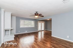 Decatur house for rent - a living room with wood floors and a ceiling fan