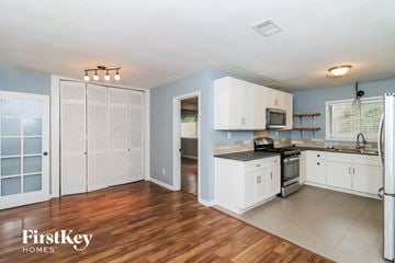 Decatur house for rent - the kitchen is clean and ready to use with white cabinets and stainless steel appliances