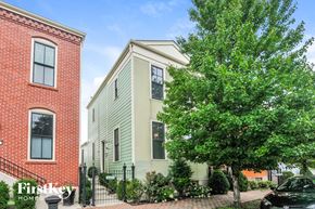 Saint Charles house for rent - A tree in front of a green house with a sign that says "FirstKey Homes".