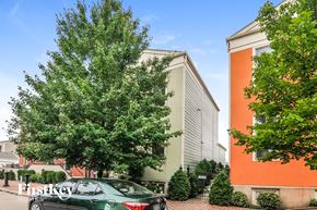 Saint Charles house for rent - A green car is parked in front of a building with a sign that says "FirstKey Homes".