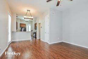 Saint Charles house for rent - A spacious room with wooden floors and a ceiling fan.